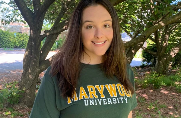 A youbg woman wearing a Marywood University T-shirt.